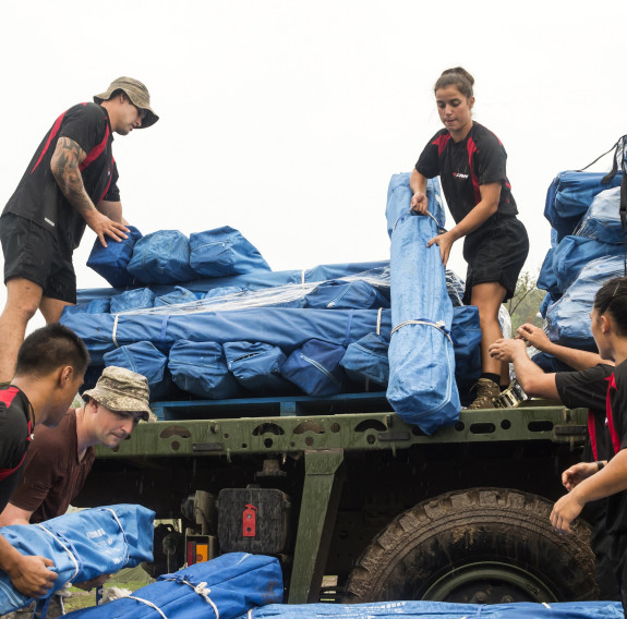 NZDF personnel unload tents from a Medium Heavy Operational Vehicle (MHOV) at the New Zealand Defence Force Forward Operating Base at Lomaloma. The tents - donated by the People's Republic of China - were taken on board HMNZS Canterbury in Suva for distri