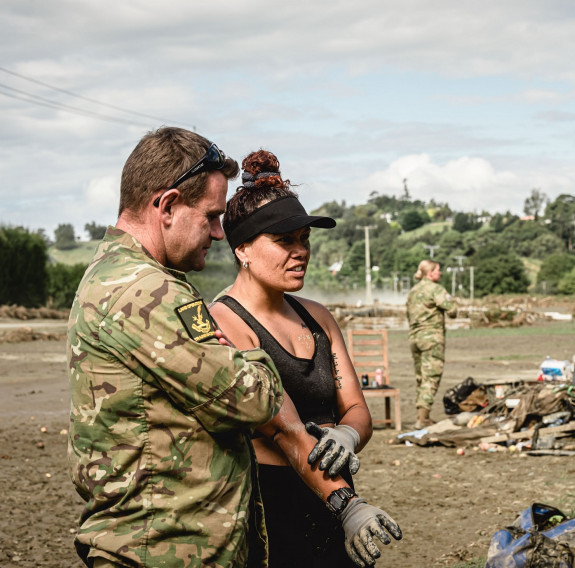 Staff Sergeant Todd Rogers talks with a former student amidst the devastation.