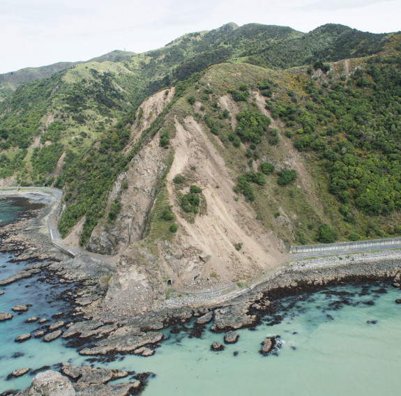 An aerial image that shows the damage from the Kaikōura earthquake around the hills - showing the slips. It shows the damaged road and seafloor.