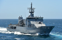 Royal New Zealand Navy's HMNZS Otago sailing on the ocean on a nice day with blue sky. 