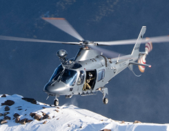 An A109 helicopter approaches a snowy mountain in the Marlborough region