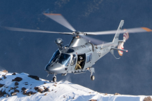 An A109 helicopter approaches a snowy mountain in the Marlborough region