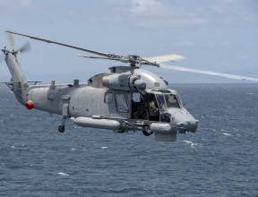 A Royal New Zealand SH-2G(I) Seasprite Helicopter flies over the ocean