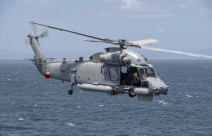 A Royal New Zealand SH-2G(I) Seasprite Helicopter flies over the ocean