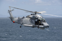 A Royal New Zealand SH-2G(I) Seasprite Helicopter flies over the ocean