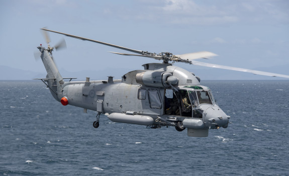 A Royal New Zealand SH-2G(I) Seasprite Helicopter flies over the ocean