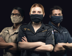 NZDF personnel with masks on and arms crossed.