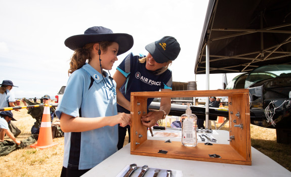 A member of the School to Skies on the Road team shows a student some of the equipment. 