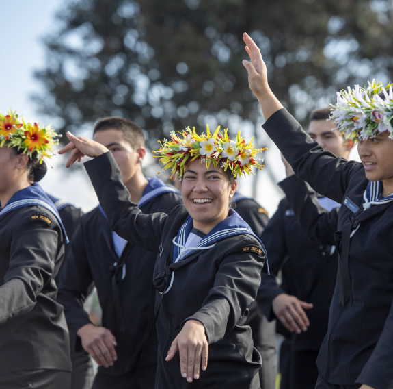 Royal New Zealand Navy sailors perform a Pacific Island dance at a Navy graduation ceremony 
