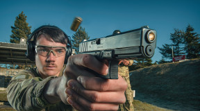 A New Zealand Army soldier fires a Glock G17 Gen 4 with another soldier standing behind them. 