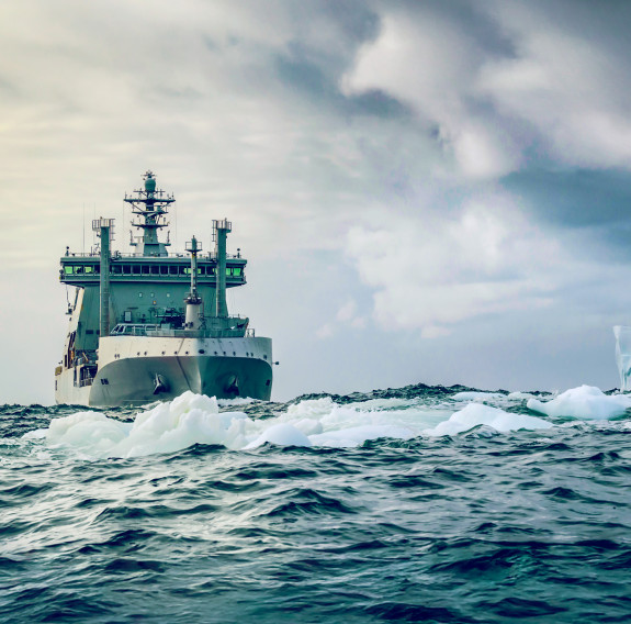 HMNZS Aotearoa, bow on in icy seas. The cloudy skies are a mood.