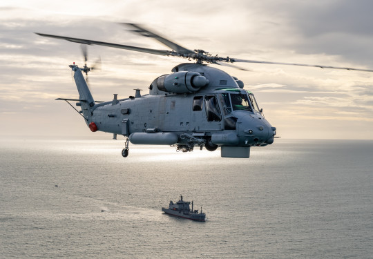 A SH-2G(I) Seasprite Helicopter helicopter hovers over HMNZS Aotearoa
