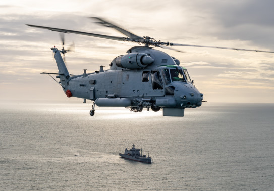 A SH-2G(I) Seasprite Helicopter helicopter hovers over HMNZS Aotearoa