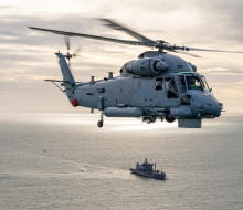 A SH-2G(I) Seasprite Helicopter helicopter hovers over HMNZS Aotearoa