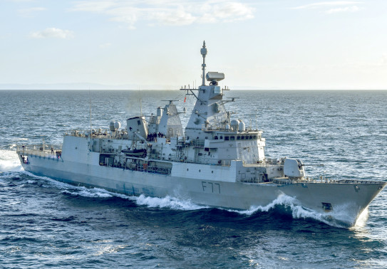 HMNZS Te Kaha sails on the ocean on a sunny day