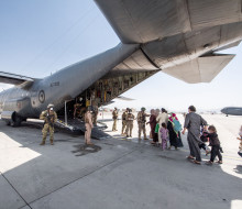 Evacuees board the Hercules aircraft at Hamid Karzai International Airport in Kabul