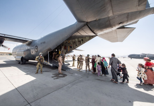 Evacuees board the Hercules aircraft at Hamid Karzai International Airport in Kabul