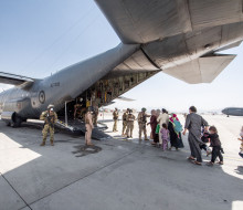 Evacuees board the Hercules aircraft at Hamid Karzai International Airport in Kabul