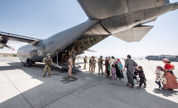 Evacuees board the Hercules aircraft at Hamid Karzai International Airport in Kabul