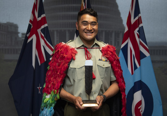 Corporal Nori Lee with the NZDF Person of the Year trophy and wearing the Kahu huruhuru, Nga Tapuwae that is awarded to the NZDF Person of the Year