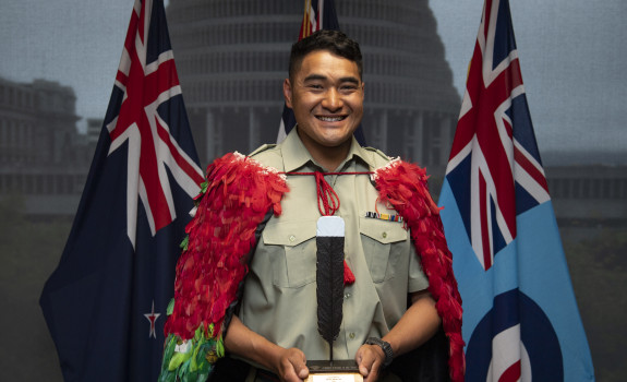 Corporal Nori Lee with the NZDF Person of the Year trophy and wearing the Kahu huruhuru, Nga Tapuwae that is awarded to the NZDF Person of the Year
