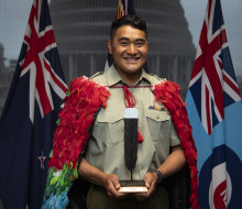 Corporal Nori Lee with the NZDF Person of the Year trophy and wearing the Kahu huruhuru, Nga Tapuwae that is awarded to the NZDF Person of the Year