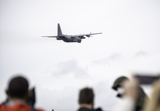A Royal New Zealand Air Force Hercules aircraft leaves Base Auckland as people watch