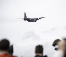 A Royal New Zealand Air Force Hercules aircraft leaves Base Auckland as people watch