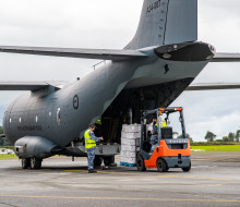 A forklift loads supplies into the rear drop-down door of the RAAF C-27 Spartan at Base Auckland.