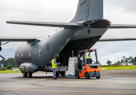 A forklift loads supplies into the rear drop-down door of the RAAF C-27 Spartan at Base Auckland.