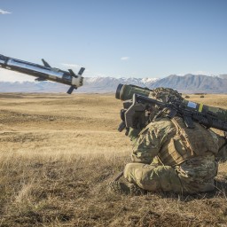 Soldier crouched down firing javelin missile