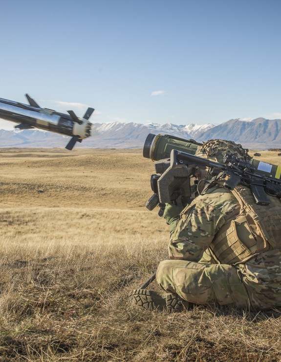 Soldier crouched down firing javelin missile