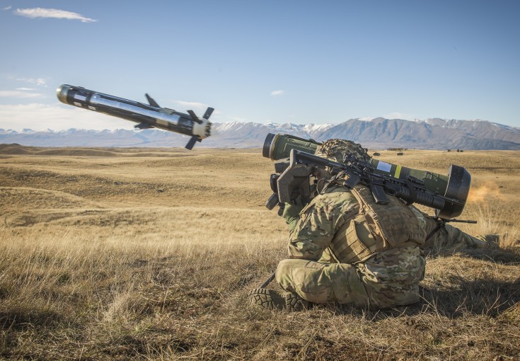Soldier crouched down firing javelin missile