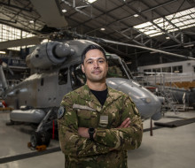 oyal New Zealand Air Force (RNZAF) engineering officer Flight Lieutenant Donté Kelly standing in front of a Seasprite.