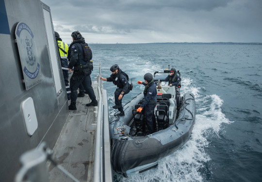 Members of the Deployable Boarding Team board custom's vessel Hawk V in the Hauraki Gulf.