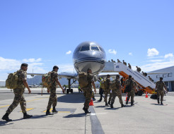 Personnel cross the tarmac in front of the RNZAF Boeing 757 and enter via the side stairs in Fiji, on route to Papua New Guinea.