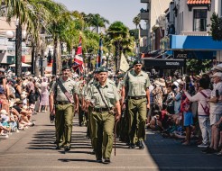 Army personnel march through the city of Napier with swords drawn, bayonets fixed, music playing and Colours flying.