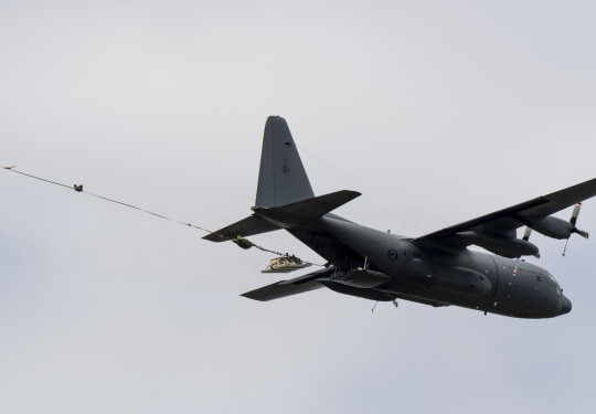 A pallet falls from a C-130H(NZ) Hercules in flight after parachute extraction during a training exercise.