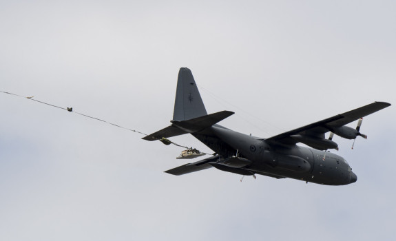 A pallet falls from a C-130H(NZ) Hercules in flight after parachute extraction during a training exercise.