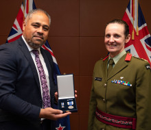 Brigadier Rose King receives the NATO Meritorious Service Medal at a ceremony at Parliament with Minister of Defence Peeni Henare