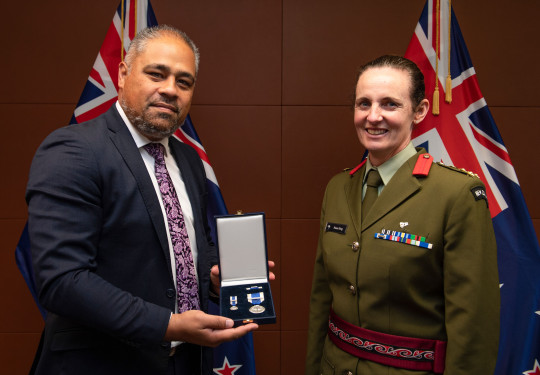 Brigadier Rose King receives the NATO Meritorious Service Medal at a ceremony at Parliament with Minister of Defence Peeni Henare