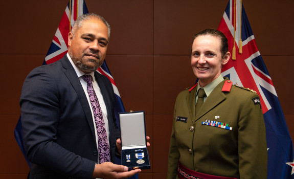 Brigadier Rose King receives the NATO Meritorious Service Medal at a ceremony at Parliament with Minister of Defence Peeni Henare