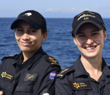 Leading Chef Monique Manuel and Able Chef Alice Wyatt both look at the camera in uniform, smiling. 