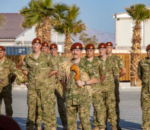 Lieutenant Colonel Williams assumes command of NZ contingent TG653.5 (pictured at the front) with a unit of Army personnel behind, standing at ease.