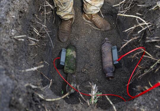 Explosive charges are placed on the Second World War ordnance for safe disposal