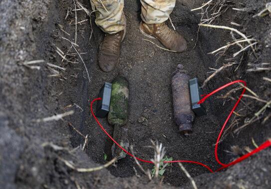 Explosive charges are placed on the Second World War ordnance for safe disposal