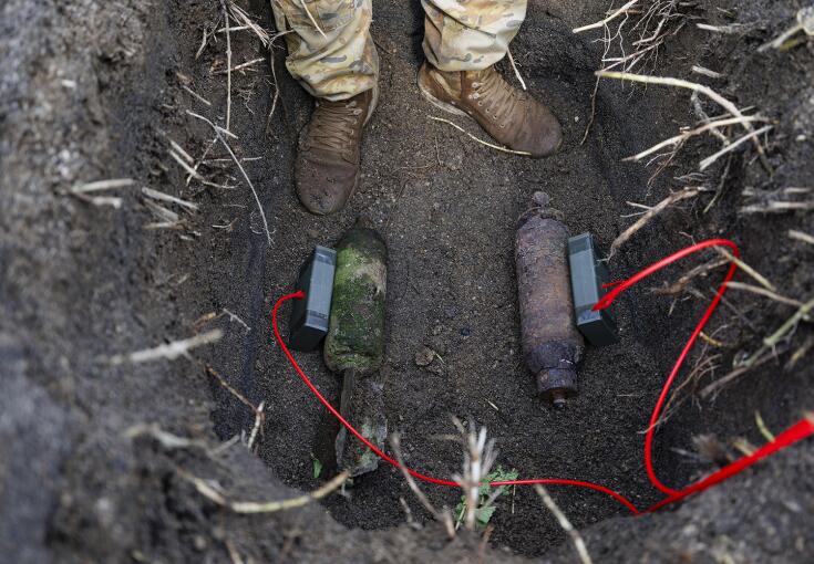 Explosive charges are placed on the Second World War ordnance for safe disposal