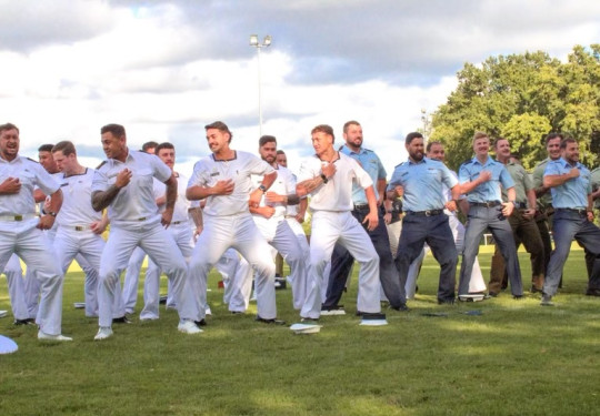 Personnel from the Royal New Zealand Navy, New Zealand Army and Royal New Zealand Air Force perform a haka at the Dave Gallaher Field.