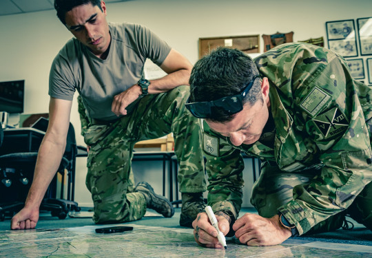 Preparing for a Search and Rescue, Private Rayner, left, and Lance Corporal Sheridan locate positions of interest on the map as part of the NZDF’s response to Cyclone Gabrielle