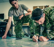 Preparing for a Search and Rescue, Private Rayner, left, and Lance Corporal Sheridan locate positions of interest on the map as part of the NZDF’s response to Cyclone Gabrielle
